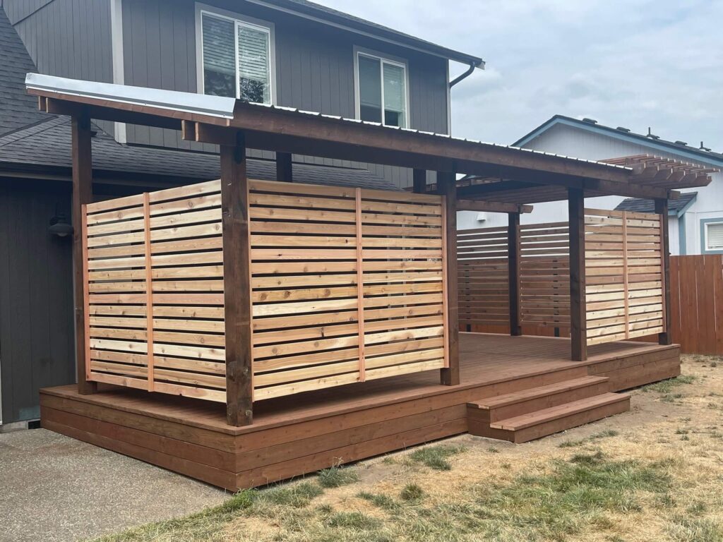 Low covered deck with horizontal wood privacy screens