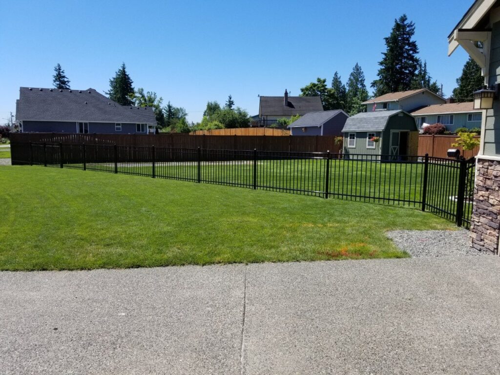 Black ornamental iron front yard fence installed by Goodrow's Fence & Deck in Pierce County